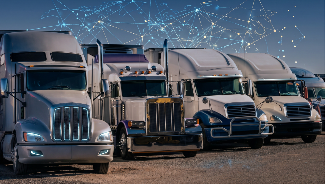 A business professional standing between rows of trucks in a freight yard